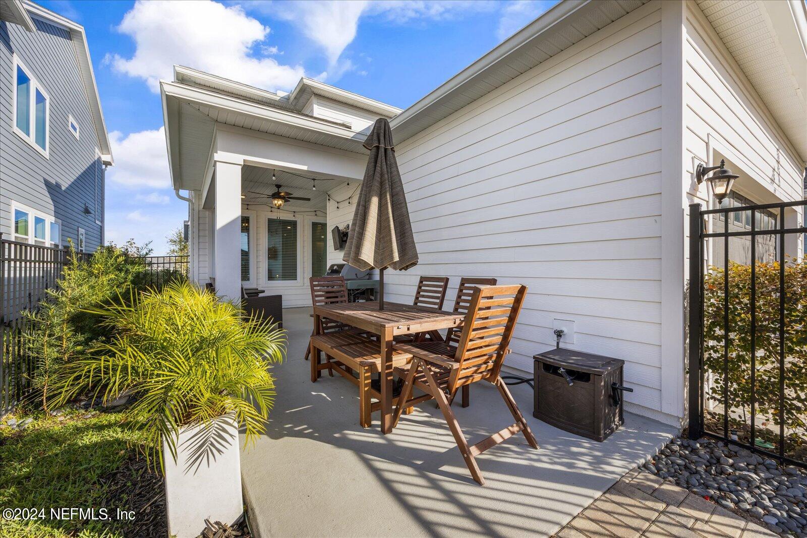 196 Ashbury Street St. Augustine, FL 32092 - Photo 21 of 35 a view of a patio with table and chairs and potted plants
