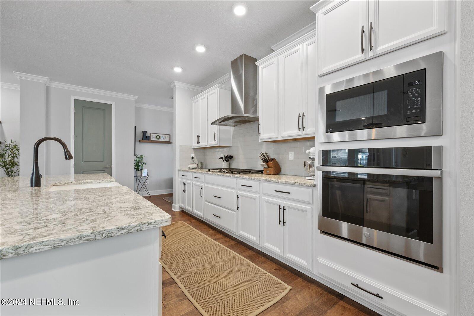 196 Ashbury Street St. Augustine, FL 32092 - Photo 10 of 35 a kitchen with stainless steel appliances granite countertop a stove microwave and sink