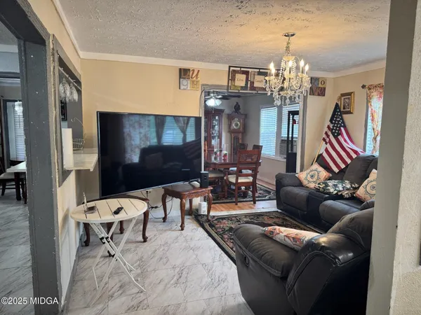 a living room with furniture and a chandelier