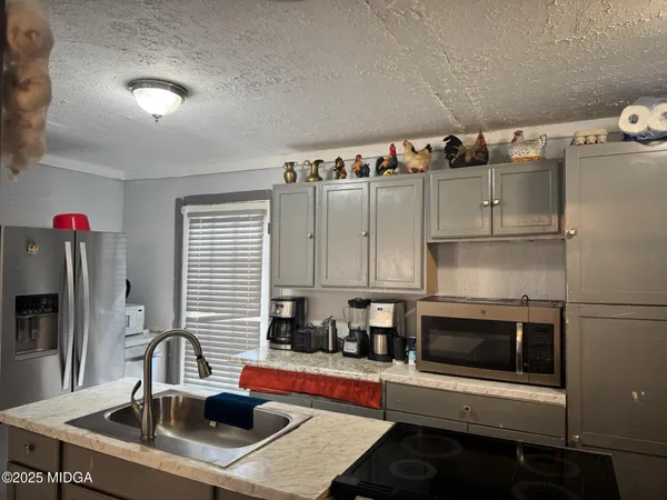 a kitchen with stainless steel appliances a sink a stove and a refrigerator