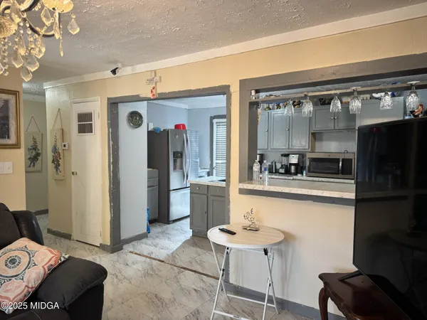 a kitchen with stainless steel appliances kitchen island granite countertop a refrigerator and a stove top oven