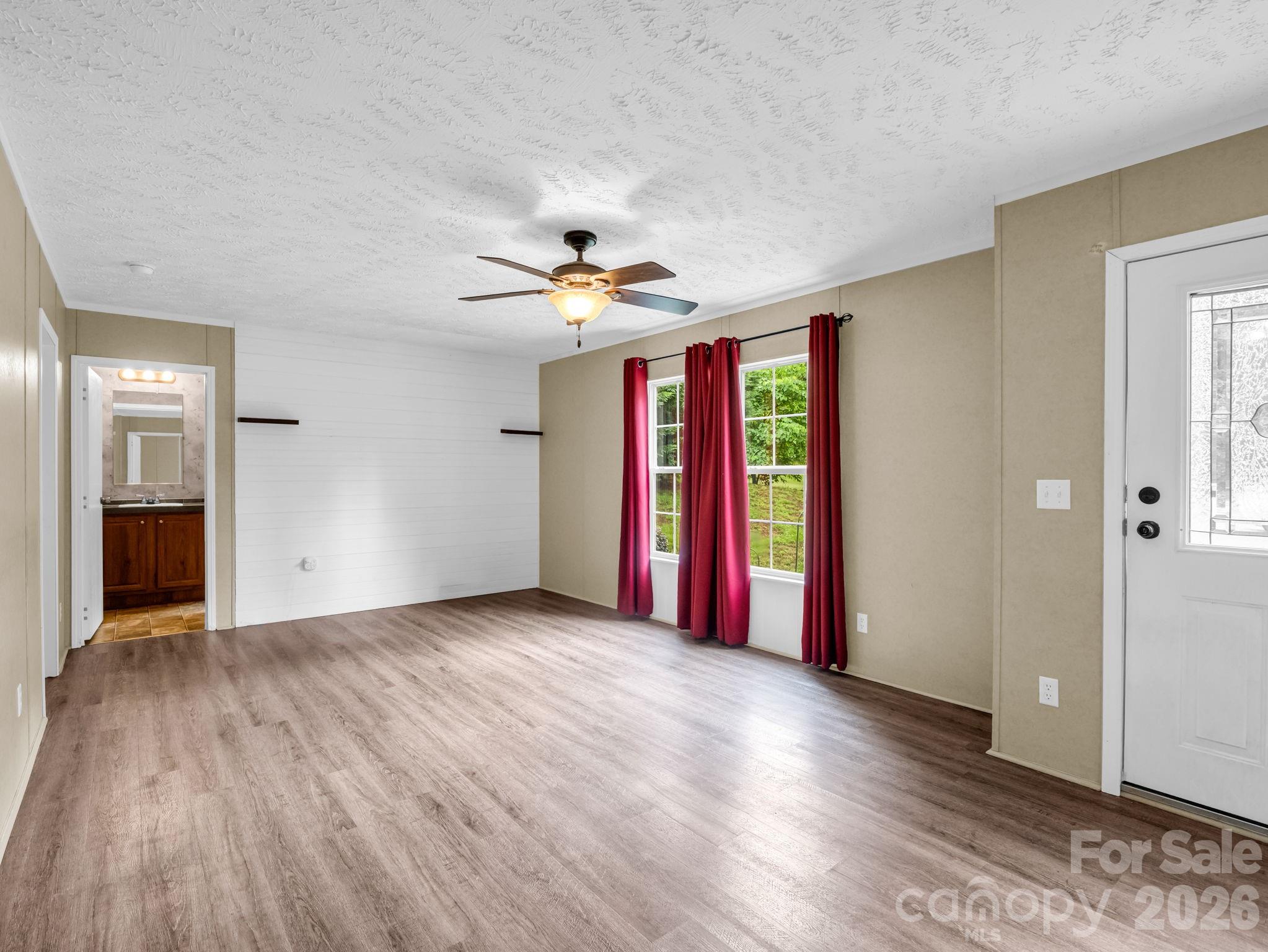 1449 Toney Road Bostic, NC 28018 - Photo 19 of 43 a view of an empty room with wooden floor and a window