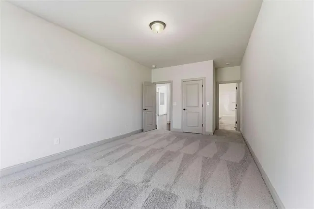 a bathroom with a granite countertop toilet sink and mirror