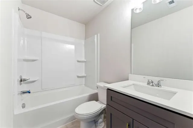 an empty room with ceiling fan and window