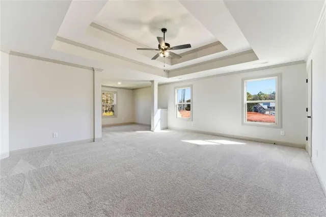 a view of a livingroom with a ceiling fan and window
