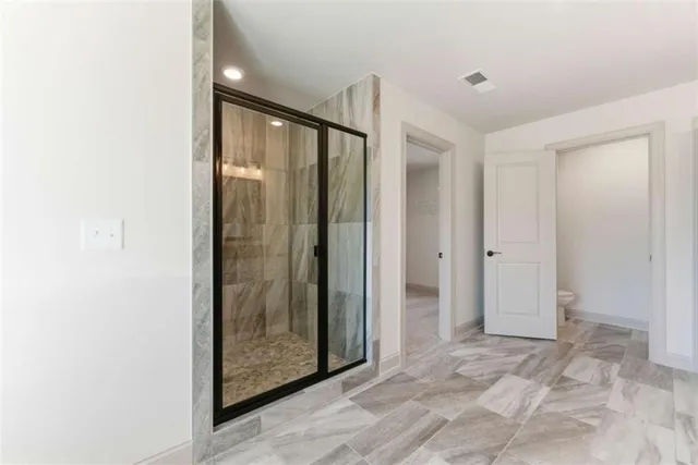 an empty room with windows and closet