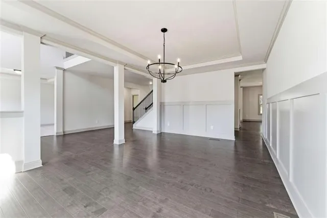 a view of a livingroom with wooden floor and a ceiling fan