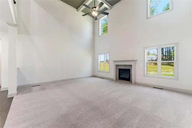 an empty room with a fireplace and a chandelier