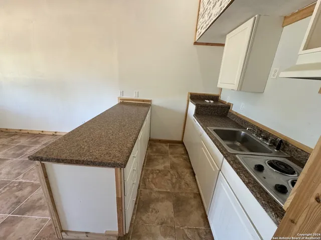 a kitchen with a stove and a refrigerator