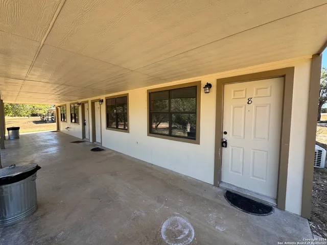 a view of a hallway with wooden floor and entryway