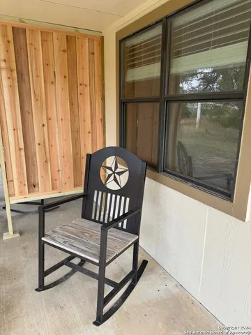 a view of a entryway door with two chairs