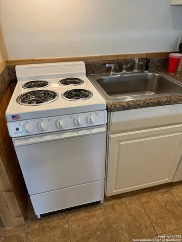 a close view of a stove top oven sitting inside of a kitchen
