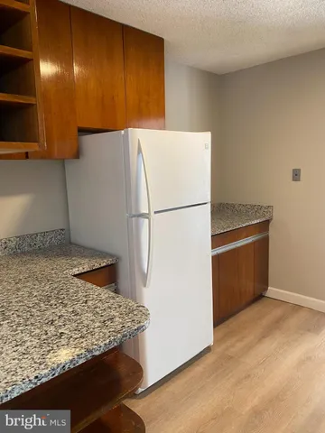 a kitchen with granite countertop a sink and cabinets