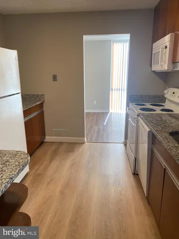 a refrigerator freezer sitting inside of a kitchen