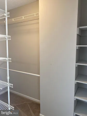 a view of a hallway with a kitchen