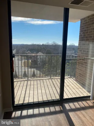 a view of balcony with wooden floor and fence