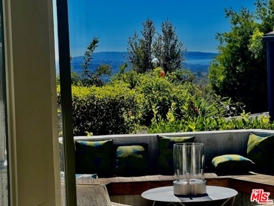 a balcony with couple of potted plants
