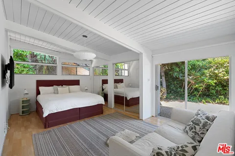 a bed room with a bed and a large window