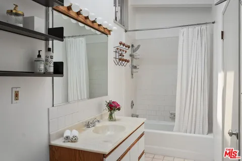 a bedroom with a bed and large window