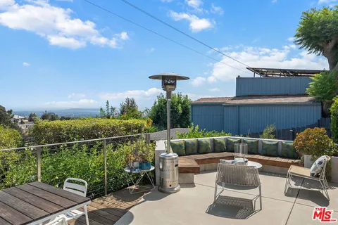 a backyard of a house with yard fountain and outdoor seating