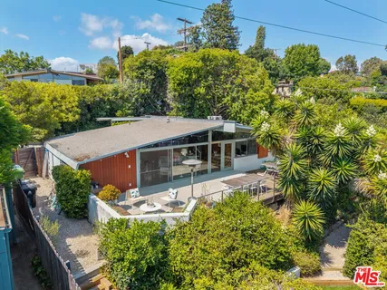 an aerial view of residential houses with city view