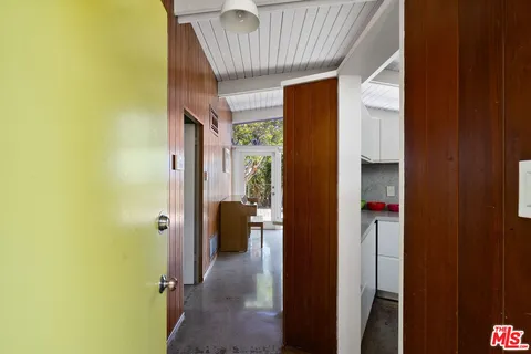 a living room with furniture and a painting