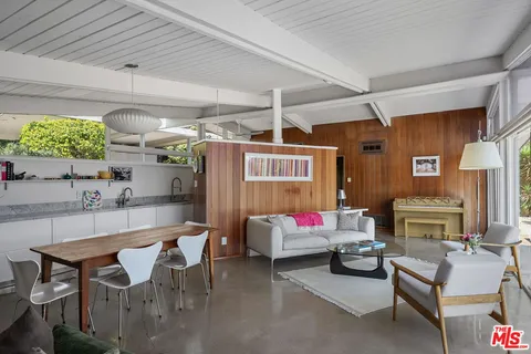 a dining table chairs in front of a building