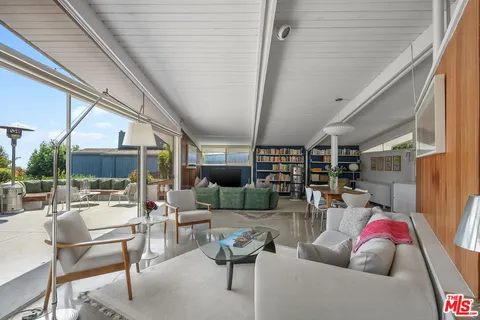 a dining room with furniture and a chandelier