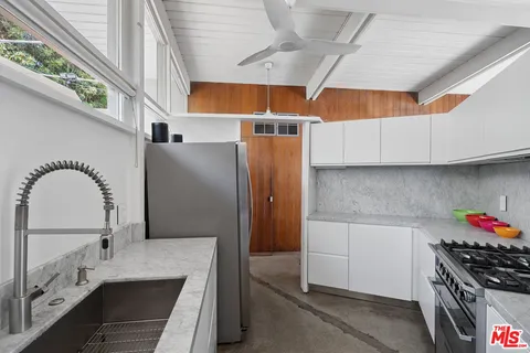 a kitchen with a stove and cabinets