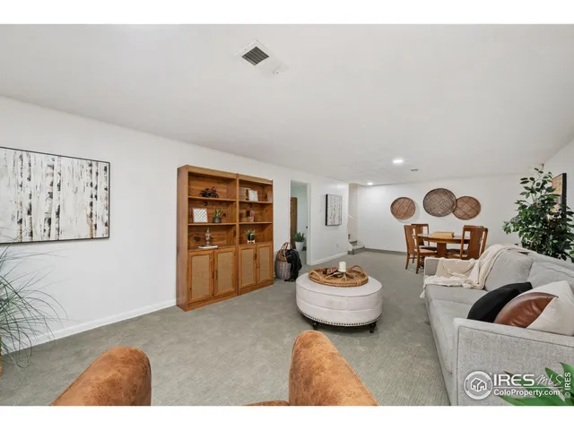 a living room with furniture and flowers