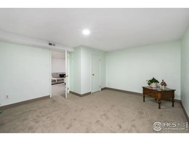 a view of an empty room and kitchen view