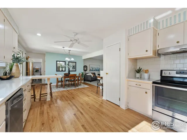 a view of a kitchen with furniture and wooden floor