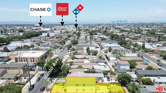 an aerial view of residential houses with yard