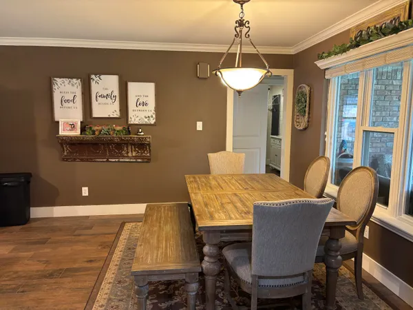 a kitchen with white cabinets and black appliances
