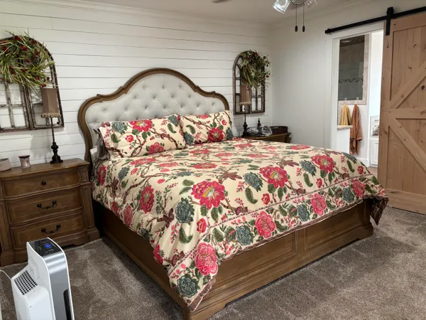a bedroom with a bed dresser and a window