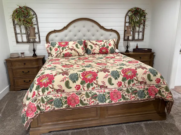 a bedroom with a bed and a mirror