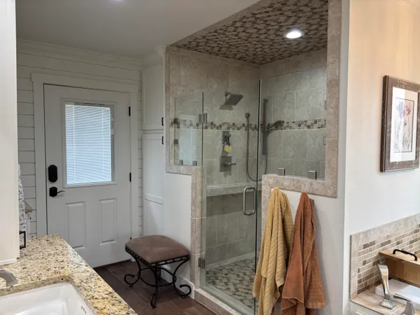 a spacious bathroom with a granite countertop sink and a mirror
