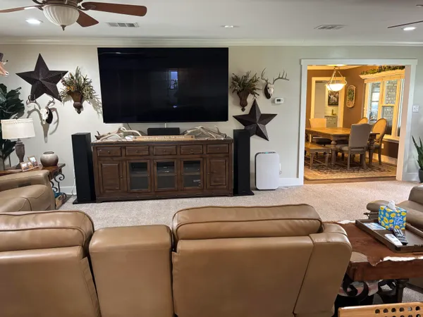 a kitchen with stainless steel appliances granite countertop a refrigerator a sink dishwasher a stove and white cabinets with wooden floor