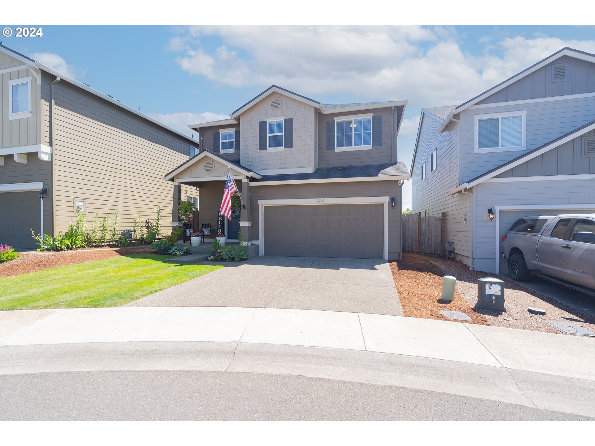 122 North 34th Court Ridgefield, WA 98642 - Photo 48 of 48 a front view of a house with a yard and garage