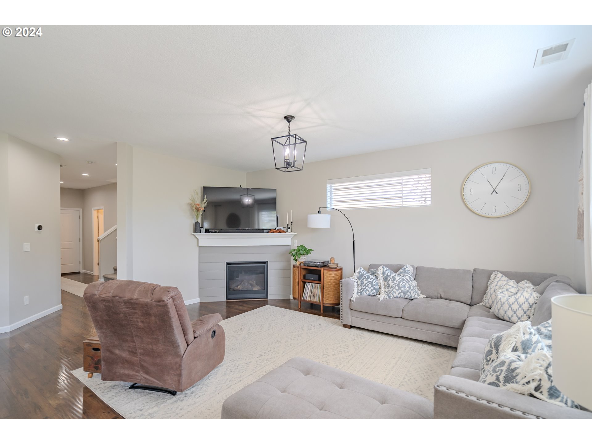 122 North 34th Court Ridgefield, WA 98642 - Photo 8 of 48 a living room with furniture a fireplace and a flat screen tv