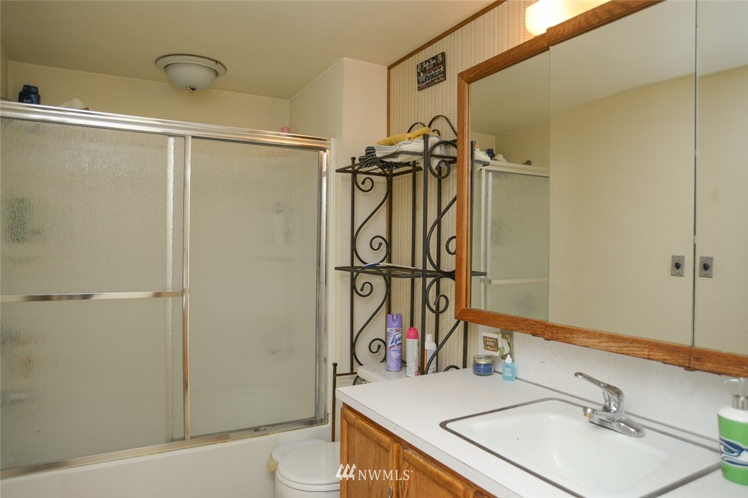13392 Avon Allen Road Mount Vernon, WA 98273 - Photo 26 of 40 a bathroom with a sink vanity mirror and shower