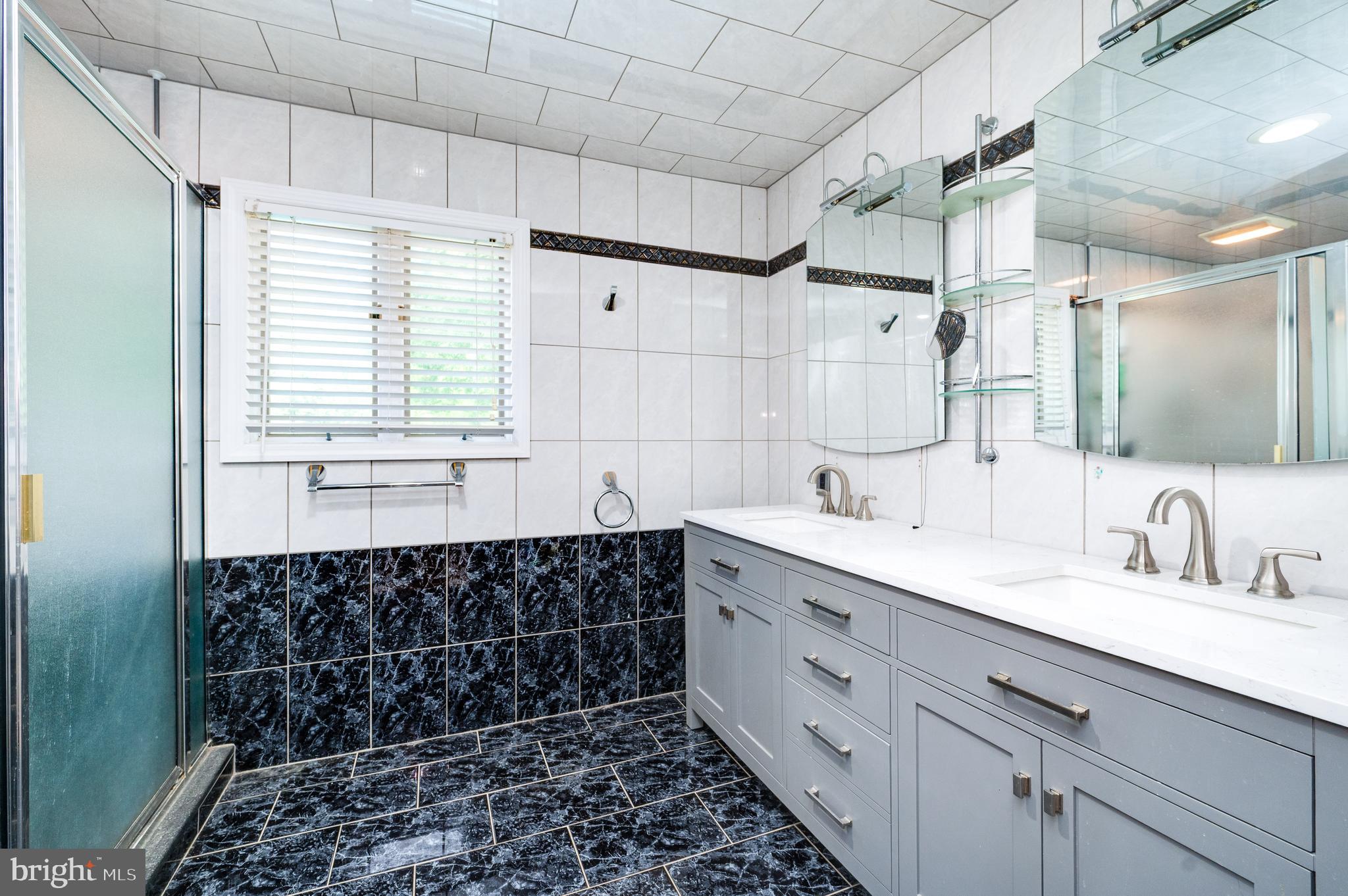 510 Greenhowe Drive Lititz, PA 17543 - Photo 23 of 31 a spacious bathroom with a double vanity sink a large mirror and a shower