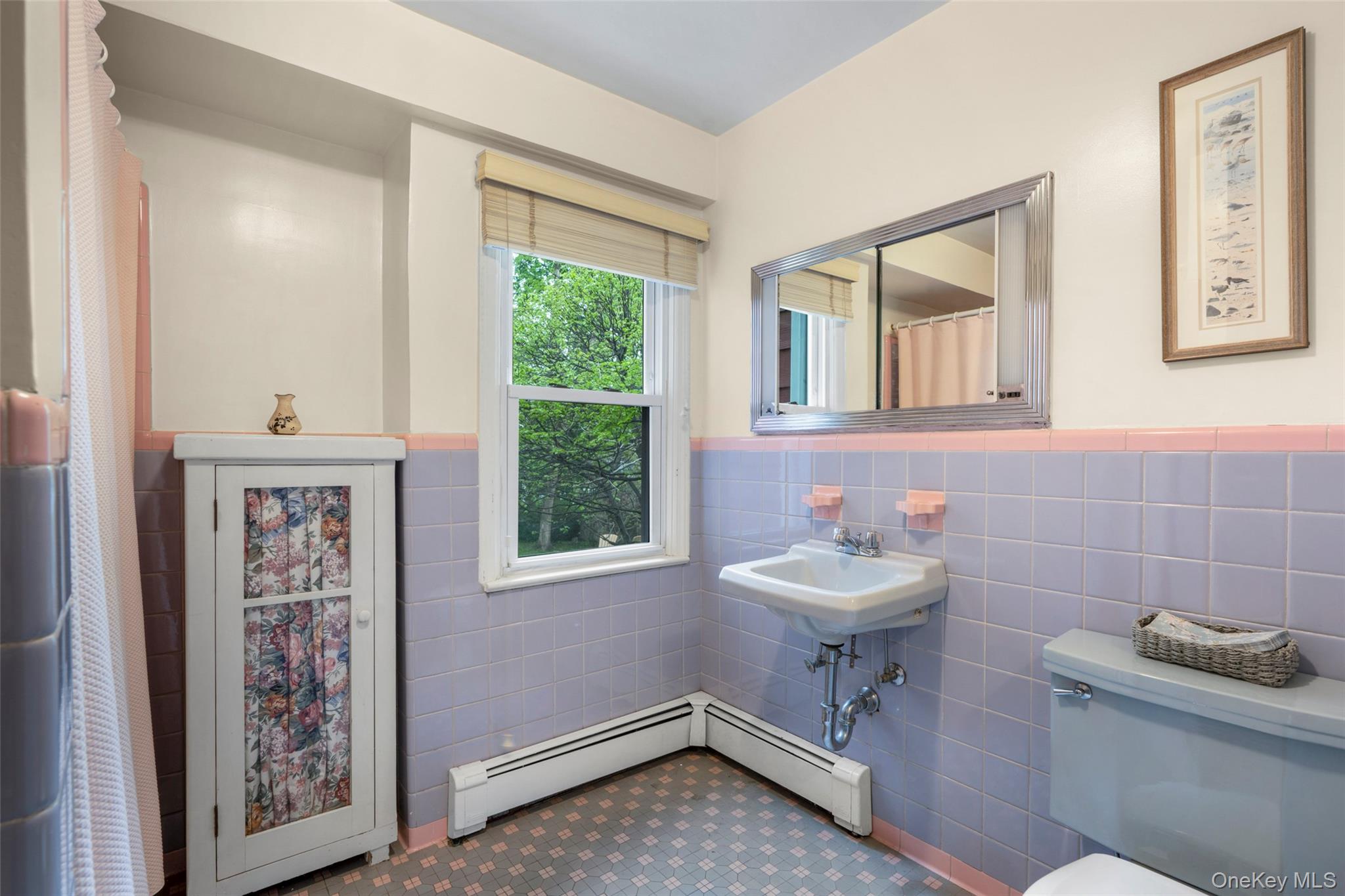 925 Old Boston Post Road Mamaroneck, NY 10543 - Photo 15 of 26 a bathroom with a sink a toilet and a mirror