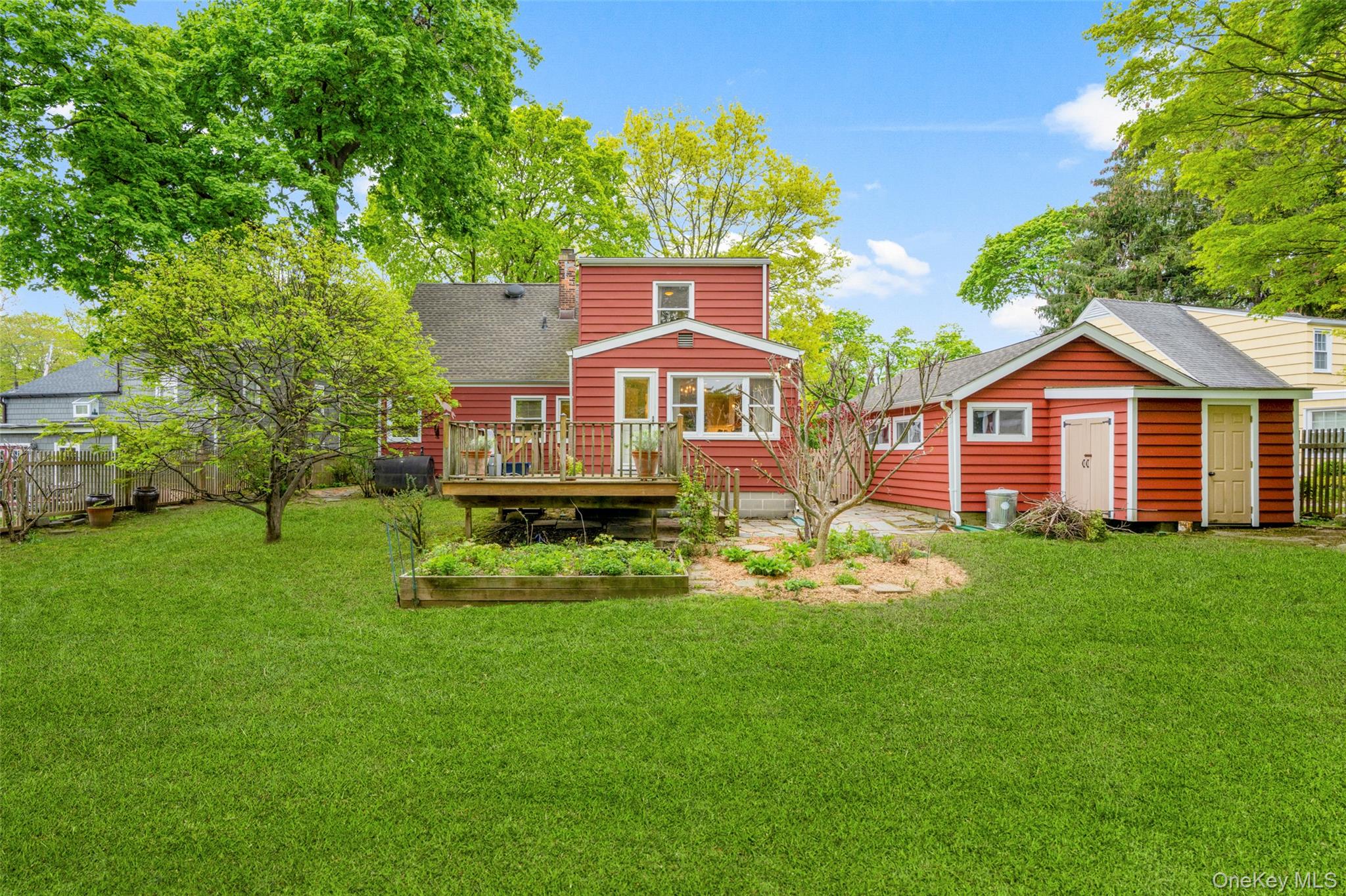 925 Old Boston Post Road Mamaroneck, NY 10543 - Photo 22 of 26 a front view of a house with a yard and trees