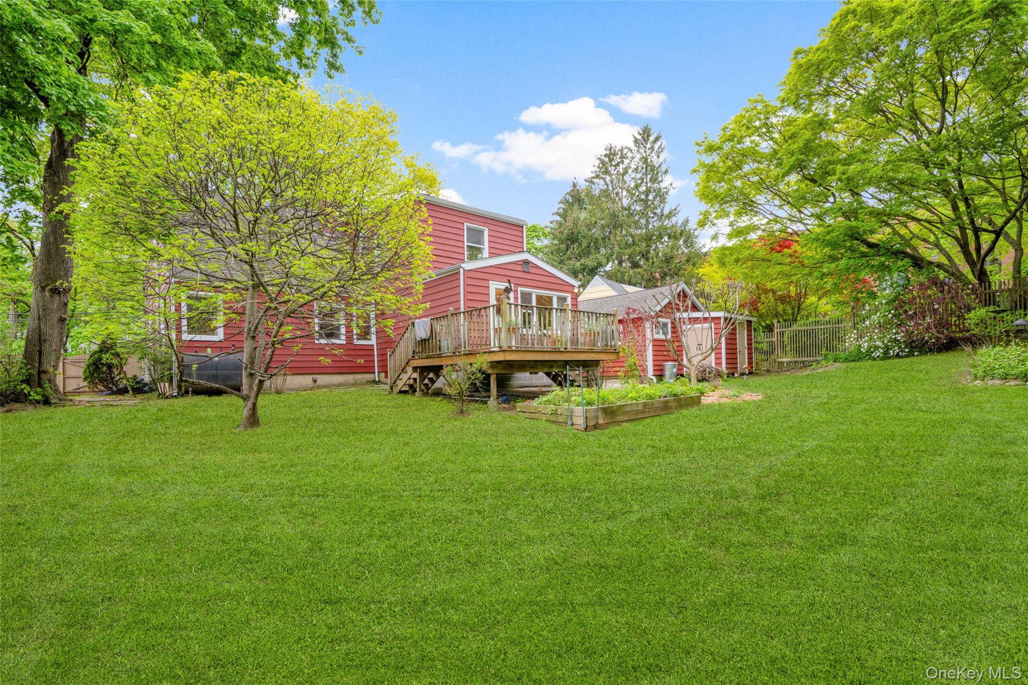 925 Old Boston Post Road Mamaroneck, NY 10543 - Photo 23 of 26 a view of a house with a big yard and large trees