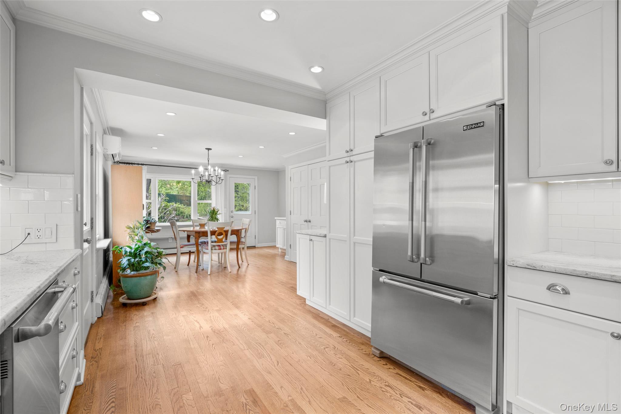 925 Old Boston Post Road Mamaroneck, NY 10543 - Photo 8 of 26 a kitchen with a refrigerator and a table chair