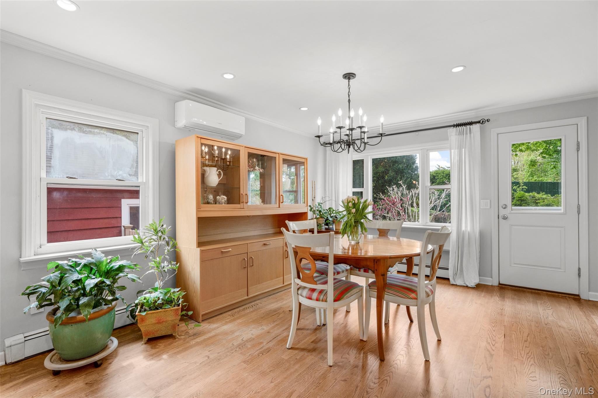 925 Old Boston Post Road Mamaroneck, NY 10543 - Photo 10 of 26 a dining room with furniture potted plants and wooden floor
