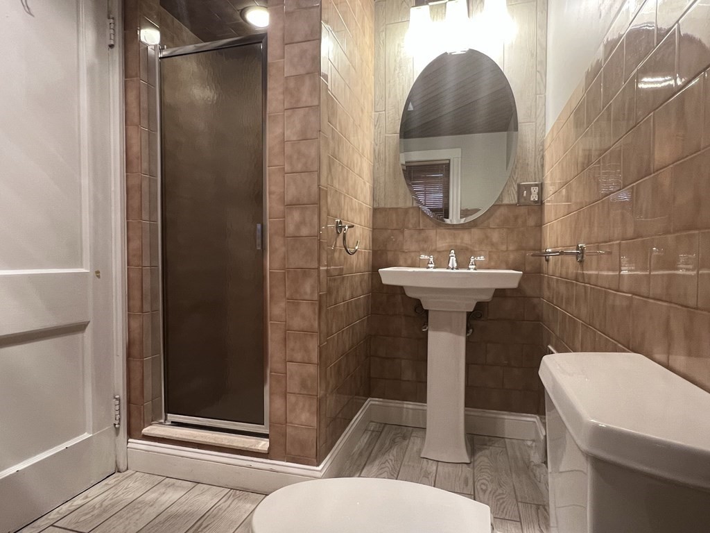 84 Winthrop Road Brookline, MA 02445 - Photo 13 of 42 a bathroom with a sink toilet and shower