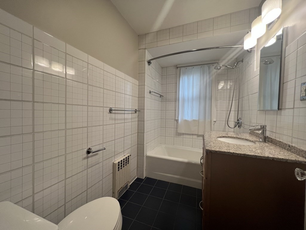 84 Winthrop Road Brookline, MA 02445 - Photo 16 of 42 a bathroom with a sink a toilet and shower