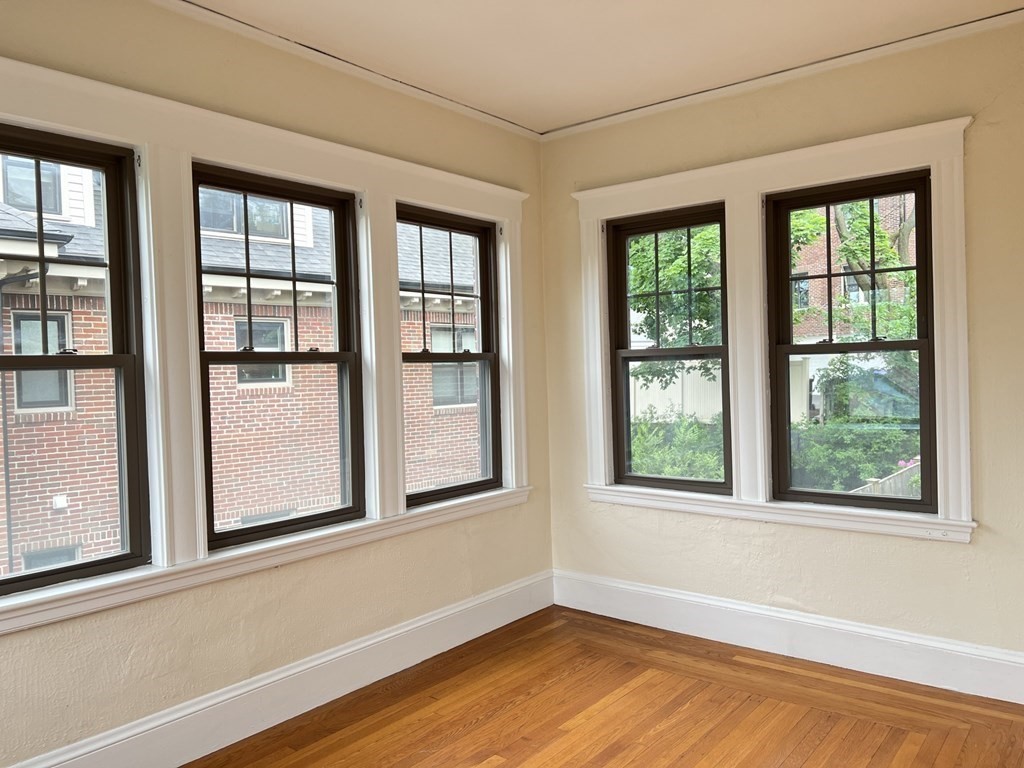 84 Winthrop Road Brookline, MA 02445 - Photo 19 of 42 a view of an empty room with wooden floor and a window